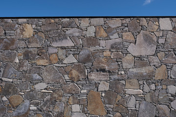Stone wall against a sunny blue sky