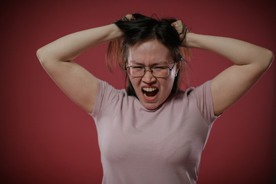 The woman tears her hair in anger.