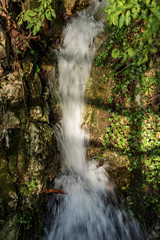 Fototapeta na wymiar Close-up of a small stream with waterfall, Canale di Tenno, Trento province, Trentino Alto Adige, Italy, Europe