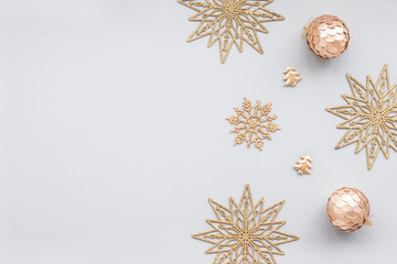 Gold christmas decoration on blue pastel background, top view, flat lay