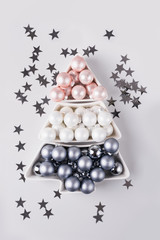 Christmas tree made of silver pastel balls on grey background. Xmas composition. Flat lay, top view, copy space. Holiday Greeting card.