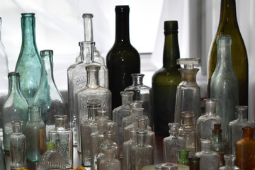 Many old and ancient vintage bottles stays on table