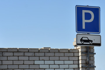 Sign Parking on white brick wall with copy space