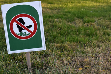 Sign Dont Walk On Grass in public park on green