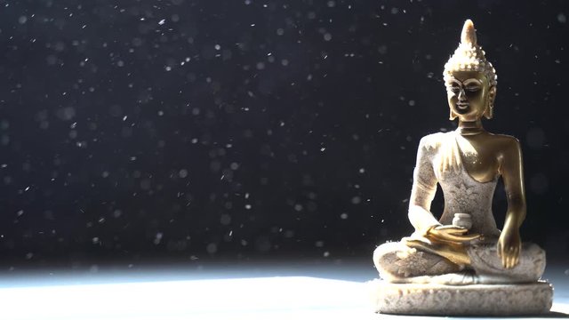 Buddha meditating during winter snowfall