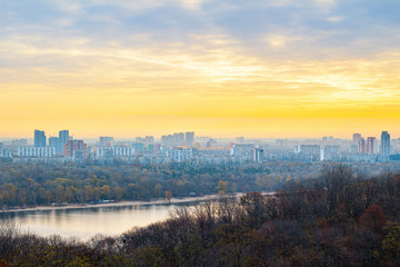 Panorama of Kyiv city and Dnipro river at sunrise in dawn, colorful autumn cityscape in the morning, Ukraine