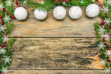 Obraz na płótnie Canvas Christmas wooden background with fir branches and white Christmas balls with copy space