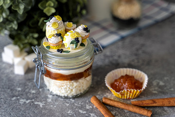 Glass jar with jam and cottage cheese