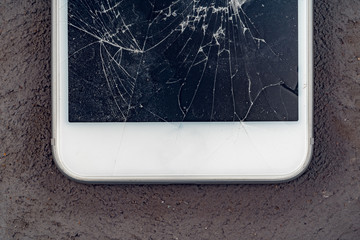 Mobile smartphone with broken screen close up