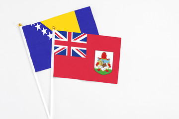 Bermuda and Bosnia Herzegovina stick flags on white background. High quality fabric, miniature...