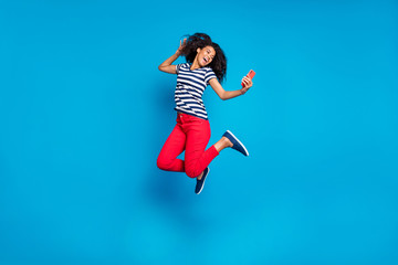 Full length body size turned photo of cheerful positive cute curly wavy pretty girlfriend jumping...