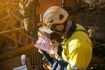 Top view of construction supervisor wearing a white safety head protection helmet prior issued the...
