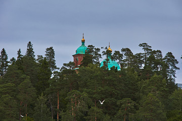 Orthodox chapel.A lonely Orthodox chapel in a forest on the shore of Lake Ladoga on the island of Valaam. The hipped roof and cross on the dome are visible. Russia, Karelia