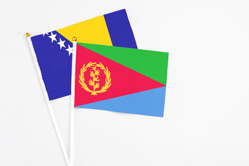 Eritrea and Bosnia Herzegovina stick flags on white background. High quality fabric, miniature national flag. Peaceful global concept.White floor for copy space.