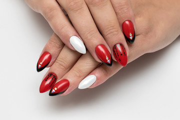 Red-black-white manicure on long sharp nails. Black French. Crystals and triangles. White pearl. Bright nails.