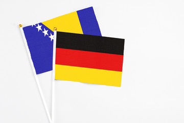 Germany and Bosnia Herzegovina stick flags on white background. High quality fabric, miniature...