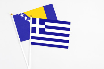 Greece and Bosnia Herzegovina stick flags on white background. High quality fabric, miniature...