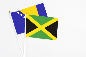 Jamaica and Bosnia Herzegovina stick flags on white background. High quality fabric, miniature...