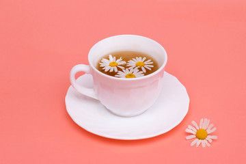Tea with camomile in a white cup. Phytotea, healthy lifestyle