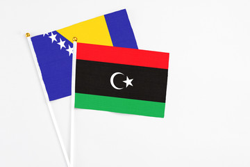 Libya and Bosnia Herzegovina stick flags on white background. High quality fabric, miniature...