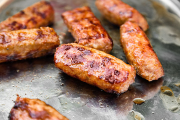 Grilling sausages on barbecue grill.Flaming charcoal grill with open fire. Concept of summer grilling, barbecue, bbq and party. Preparing homemade meal.