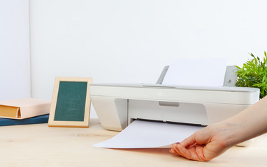 Hands of a woman using a copying machine close up