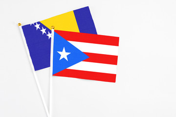 Puerto Rico and Bosnia Herzegovina stick flags on white background. High quality fabric, miniature national flag. Peaceful global concept.White floor for copy space.