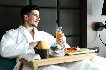 Breakfast in bed, cozy hotel room.