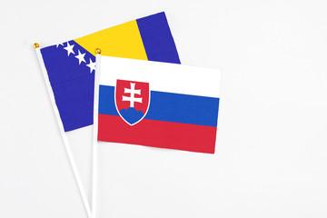 Slovakia and Bosnia Herzegovina stick flags on white background. High quality fabric, miniature...