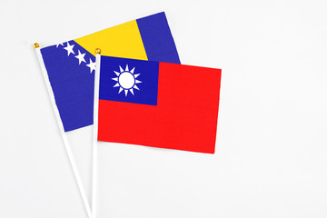 Taiwan and Bosnia Herzegovina stick flags on white background. High quality fabric, miniature national flag. Peaceful global concept.White floor for copy space.