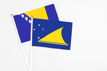 Tokelau and Bosnia Herzegovina stick flags on white background. High quality fabric, miniature...