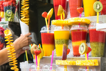 Cold fruit juice on ice in a market.