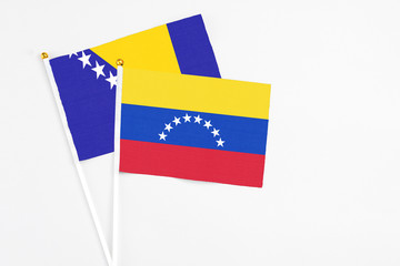 Venezuela and Bosnia Herzegovina stick flags on white background. High quality fabric, miniature national flag. Peaceful global concept.White floor for copy space.