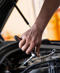 Picture of a man servicing the car