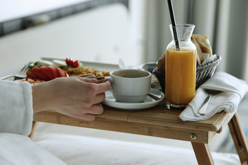 Breakfast in bed, cozy hotel room. 
