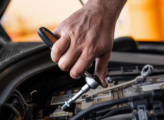 Picture of a man servicing the car