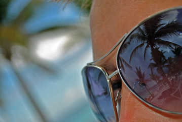 Reflection of paradise in glasses