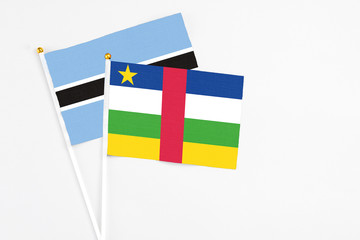 Central African Republic and Botswana stick flags on white background. High quality fabric, miniature national flag. Peaceful global concept.White floor for copy space.