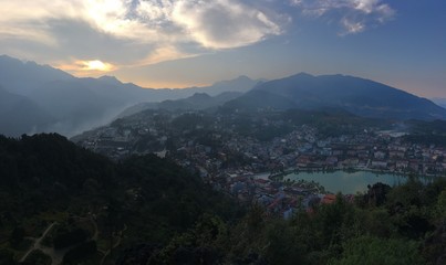 Fototapeta premium sunset in the mountains, aerial view of the city, Sapa city, North Vietnam, European style city view