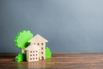 Figures of houses and trees. Affordable comfortable housing. Purchase of apartments and real estate, rent and sale. Housing, new home. Modern architecture. Mortgage. Urban Studies and Planning