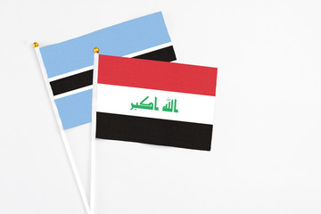 Iraq and Botswana stick flags on white background. High quality fabric, miniature national flag. Peaceful global concept.White floor for copy space.