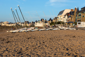 Fototapeta na wymiar Catamarans and sand yachts on the beach in Saint Malo. Brittany, France