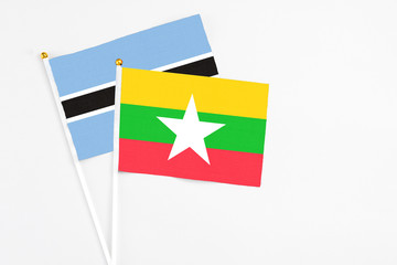 Myanmar and Botswana stick flags on white background. High quality fabric, miniature national flag. Peaceful global concept.White floor for copy space.