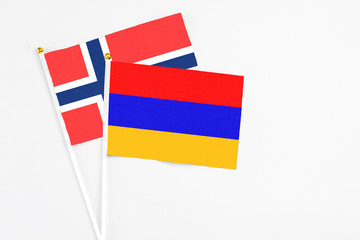 Armenia and Bouvet Islands stick flags on white background. High quality fabric, miniature national flag. Peaceful global concept.White floor for copy space.