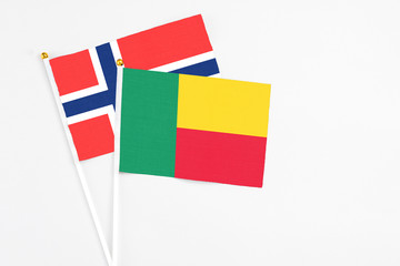 Benin and Bouvet Islands stick flags on white background. High quality fabric, miniature national flag. Peaceful global concept.White floor for copy space.