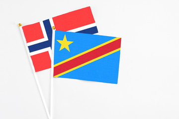 Congo and Bouvet Islands stick flags on white background. High quality fabric, miniature national flag. Peaceful global concept.White floor for copy space.