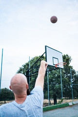 Young basketball player shooting a triple
