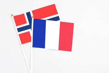 France and Bouvet Islands stick flags on white background. High quality fabric, miniature national flag. Peaceful global concept.White floor for copy space.