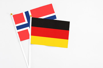 Germany and Bouvet Islands stick flags on white background. High quality fabric, miniature national flag. Peaceful global concept.White floor for copy space.