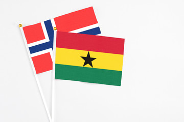 Ghana and Bouvet Islands stick flags on white background. High quality fabric, miniature national flag. Peaceful global concept.White floor for copy space.